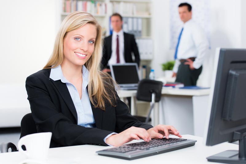 Loan officer working at a computer in a mortgage office